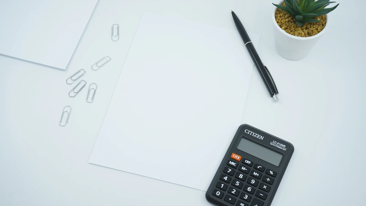 Calculator, paperwork, and a pen on a light desk