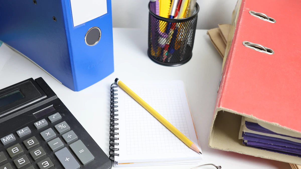 Document binders, a notebook, and stationery arranged on a desk